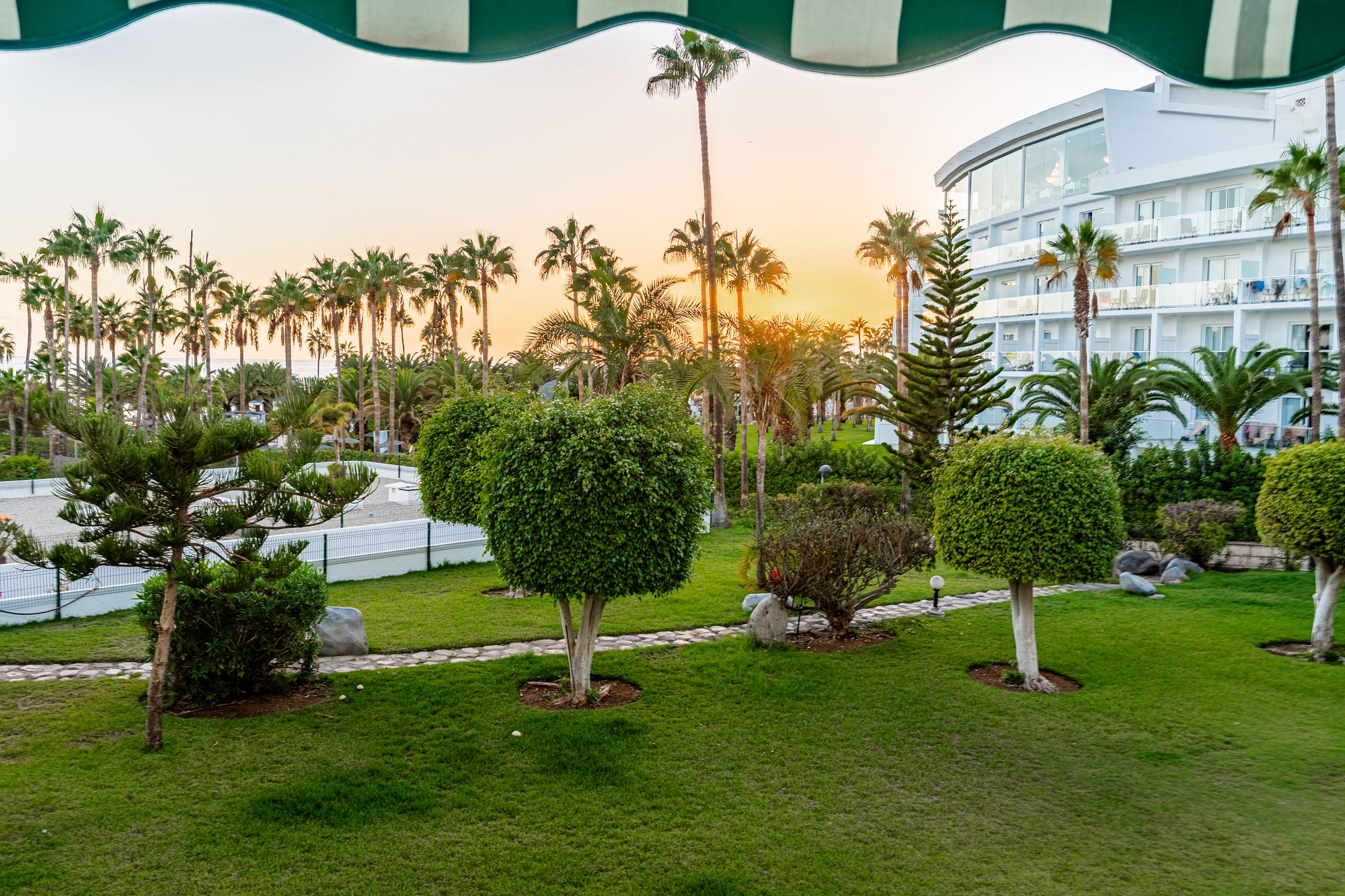 Sunset over the tropical gardens of Altamira, seen from the apartment terrace